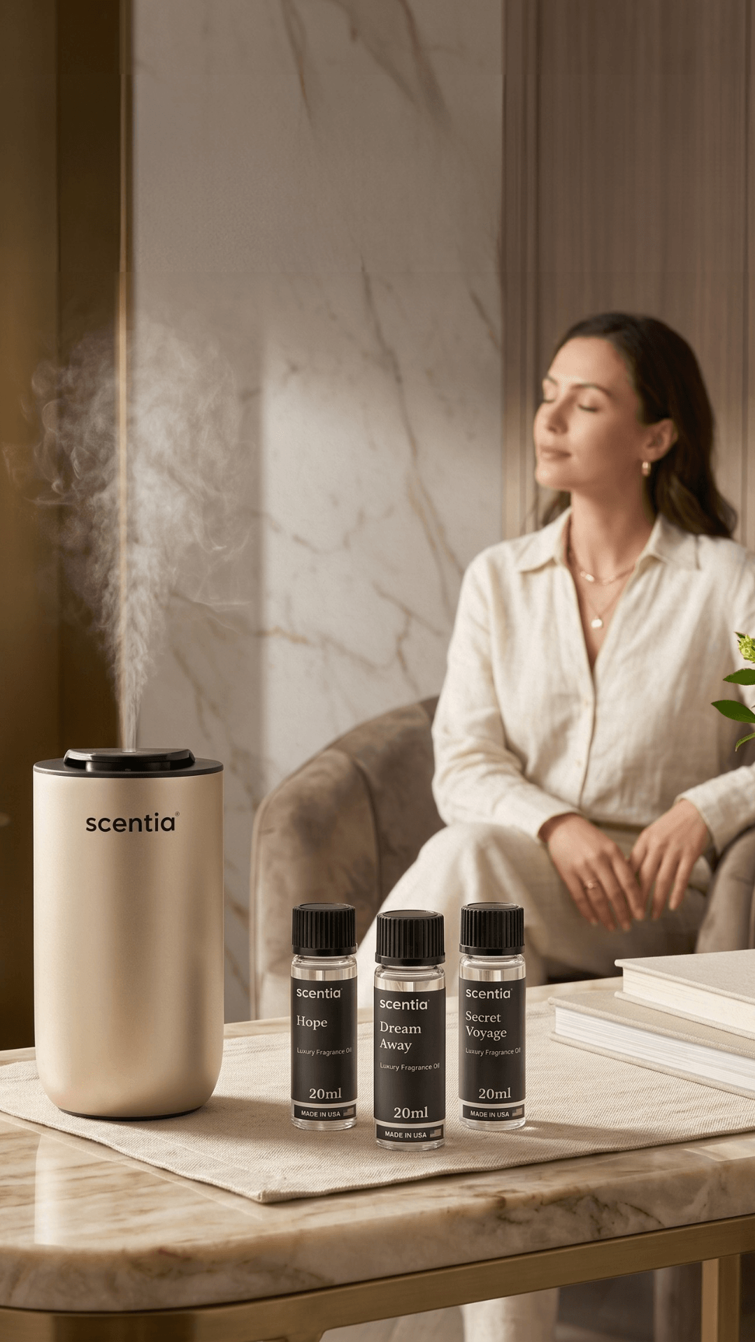 Woman sitting on a sofa with a scent diffuser and three small bottles on a table, in a modern room.